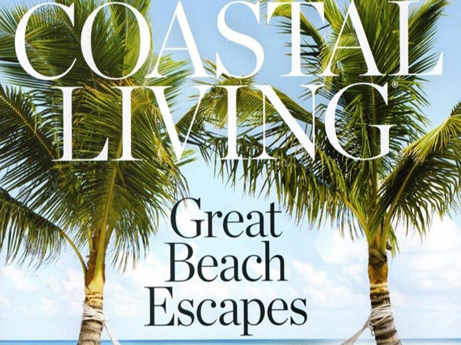 With palm trees in the background, this picture shows Coastal Living magazines cover titled 